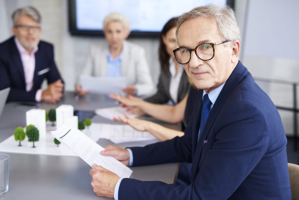 portrait of senior businessman during a conference 2026 01 06 10 56 35 utc 1 scaled.jpg